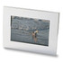 A nickel plated photo frame showcasing a beach scene with a child playing by the water.