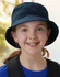 A navy soft washed bucket hat featuring eyelets, worn by a smiling child with a ponytail.