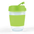 A reusable coffee cup with a transparent body and a bright green lid and sleeve. It has a logo present.