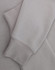 A light grey crewneck sweatshirt with a soft texture, featuring long sleeves and a cuffed hem.