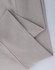 A close-up of a light beige polar fleece jumper featuring a half-zip collar. It has a simple design with a logo.