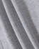 A close-up of soft grey fabric, highlighting multiple folds and textures of a fleecy hoodie.