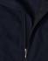 A close-up of a navy softshell vest featuring a zippered front and a fleece lining. The vest has a logo on it.