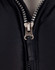 A heavy quilted black jacket with a silver zip featuring the brand logo, showcasing a close-up of the zipper area.
