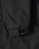 A close-up of a black long line stadium jacket featuring adjustable wrist cuffs and a logo.