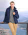 A navy blue insulated puffer jacket with a 3D cut, worn by a woman against a scenic outdoor backdrop.