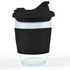 A reusable coffee cup with a clear body and a black snap lid and sleeve for grip.