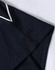 A close-up of a navy blue polo shirt featuring a white trim on the collar and sleeve.