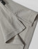 A light grey polo shirt featuring detailed stitching and a branded label at the collar.