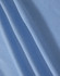 A close-up of light blue fabric with a textured surface, suitable for polo shirts. It has a branding logo.