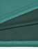 A fabric close-up of a teal bamboo charcoal polo shirt, featuring textured and dotted patterns.