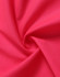 A swirl of bright pink fabric, showcasing a textured surface ideal for safety apparel.