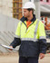 Hi-Vis two-tone rainproof safety jacket in yellow and navy, featuring 3M reflective tape, worn by a worker with a hard hat.