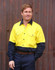 A long-sleeve, high-visibility shirt in yellow and navy blue with a logo, featuring two chest pockets.