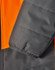 A close-up of a hi-vis quilted safety jacket featuring orange and dark grey colours, with a focus on the sleeve detail.