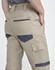 Cuffed unisex work pants in khaki, featuring multiple pockets and a waistband with elastic. Includes branding.
