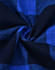 A close-up of unisex flannel plaid fabric in shades of blue and black, featuring a traditional check pattern.