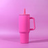 A drink bottle in bright pink with a handle and a straw, featuring a simple design and a logo.