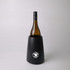 A black wine cooler with a sleek design, featuring a drink bottle inserted inside and a logo on the front.