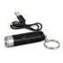 A black rechargeable torch keyring with a silver front, accompanied by a USB charging cable.