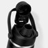 A drink bottle with a black matte finish, featuring a wide opening and a handle, along with a logo.