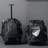 A black wheeled backpack with a retractable handle, featuring multiple compartments and zippers.