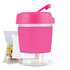 A pink reusable coffee cup with a clear base and a lid, accompanied by a bag of colorful jelly beans.