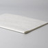 A white notebook with a textured cover lying flat on a grey surface. It features a subtle seam along one edge.