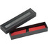 A sleek black box with a grid-patterned lid, containing a red stylus pen rolled in protective material.