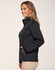 A women's softshell jacket in dark navy, featuring a high collar and side pockets, with a logo on the chest.