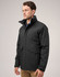 A black unisex quilted waterproof jacket with a high collar and side pockets displayed on a model.