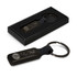 A rectangular black key ring with a metal ring, presented in a black box, featuring a logo.