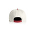 A two-tone cap featuring a cream front and red back, with an adjustable snapback closure and branding.