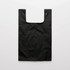 A reusable grocery bag in black, featuring a simple design and a button closure. It has a logo on one side.