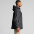 A black rain jacket with a hood, featuring a side zip pocket and a logo on the sleeve.
