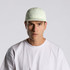 A light green nylon cap features a structured design and has a logo on the front.