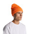 An orange beanie is worn by a model with a neutral expression, paired with a plain white T-shirt.