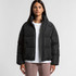 A puffer jacket in black, featuring a zip-up front and a casual, oversized fit. The model wears a white top underneath.