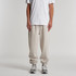 Relax Track Pants in beige, featuring a relaxed fit and elastic cuffs, paired with a plain white t-shirt and sneakers.