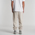 Relax Track Pants in a light beige hue, featuring a relaxed fit and cuffed ankles. The model is shown from behind.