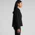 A model wearing a black canvas chore jacket, with a side view showcasing its design and silhouette.
