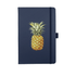 A navy journal with a pineapple illustration on the cover. It features an elastic band closure and has branding.