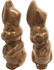 A pair of chocolate Easter bunnies in light brown, featuring smiling expressions and detailed features.