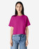 A vibrant fuchsia women's boxy T-shirt with a relaxed fit, paired with light blue jeans. Features a branding logo.