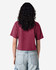 A maroon women's fine jersey boxy T-shirt, viewed from the back, paired with light blue baggy jeans.