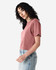 A model wears a dusty rose American Apparel women's fine jersey boxy T-shirt, featuring a relaxed fit and short sleeves.