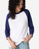 A white and navy unisex raglan T-shirt with three-quarter sleeves, featuring a logo.