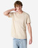 A unisex henley T-shirt in beige, featuring a round neckline and short sleeves, displayed on a model.