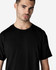 A black Gildan Light Cotton T-Shirt on a male model, featuring a simple round neckline and short sleeves.