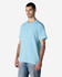 A light blue Gildan Light Cotton T-Shirt displayed on a model, featuring a simple design and relaxed fit.